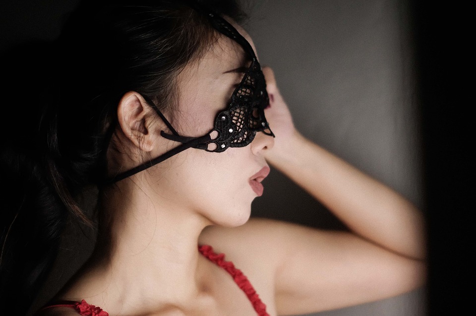 Cam girl wearing a mask.